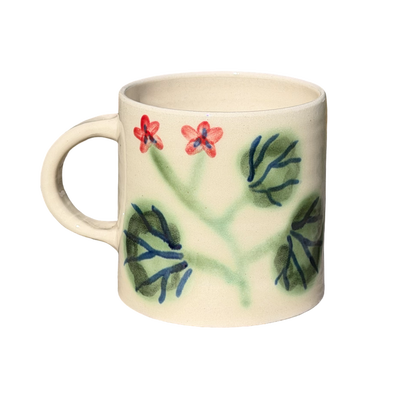 Ceramic mug with floral design on a white background