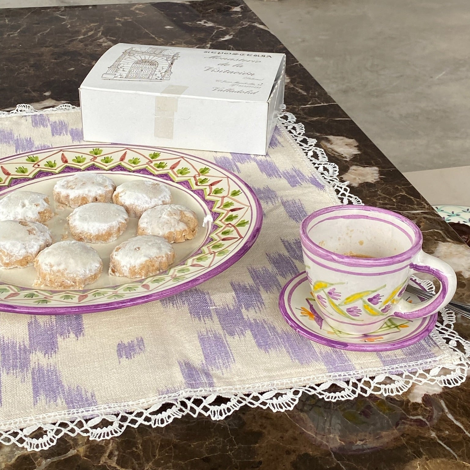 Teacup with cookies on a ceramic  on a tablecloth - lifestyle