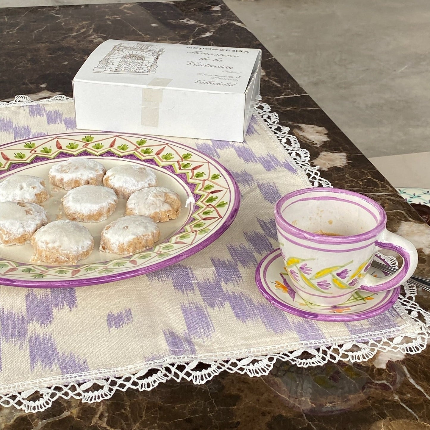 Teacup with cookies on a ceramic  on a tablecloth - lifestyle