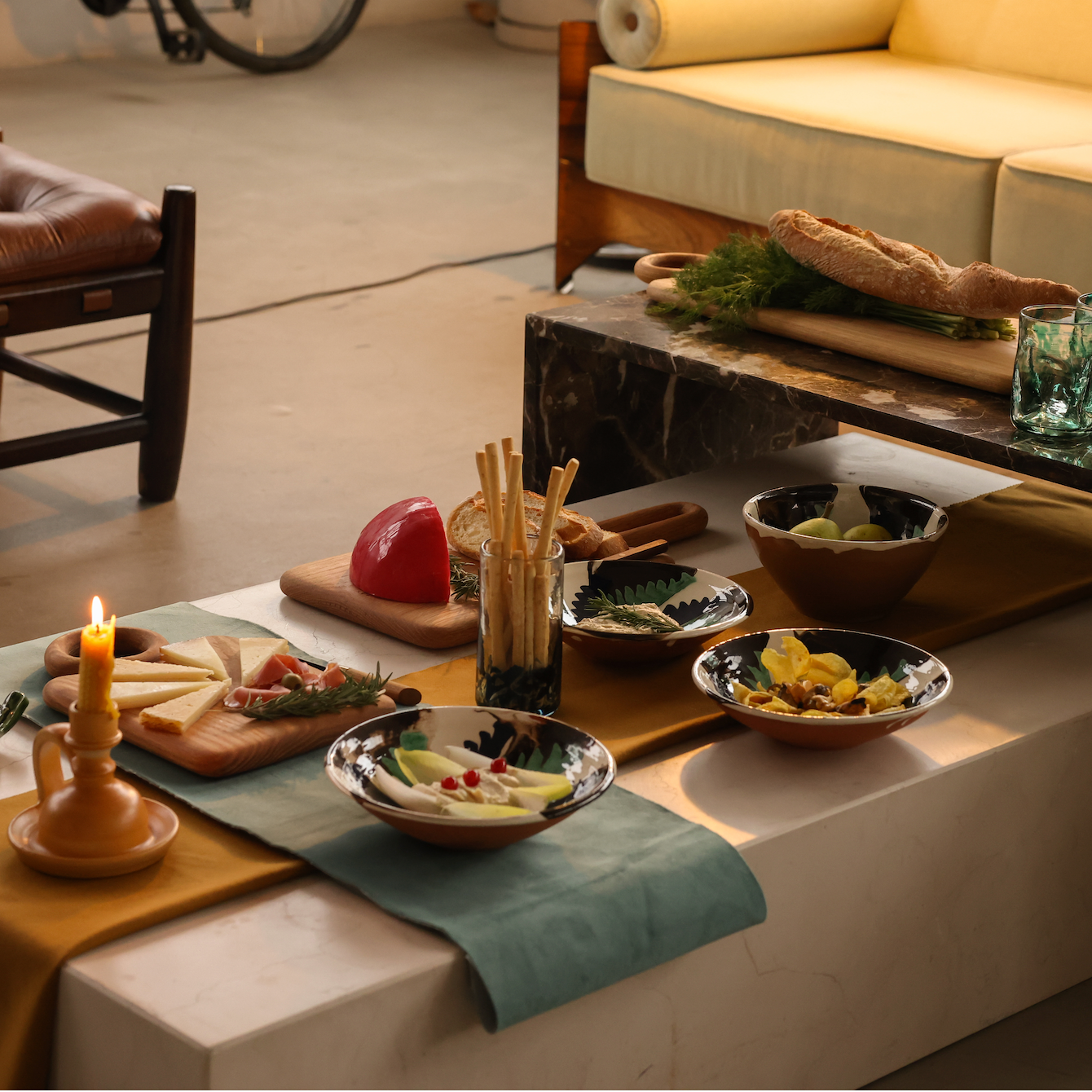 Dining table with appetizers and a candle in a cozy indoor setting - lifestyle