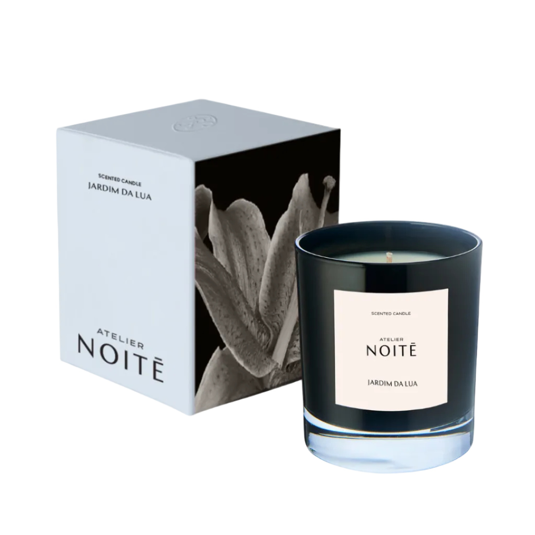 Black candle labeled 'Atelier Noité' with packaging on a white background