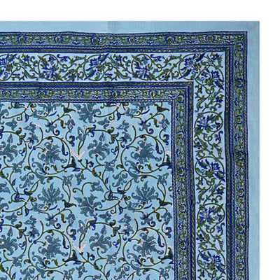 A rectangular tablecloth with a sky blue base and an intricate floral jaal pattern, displayed on a white background.