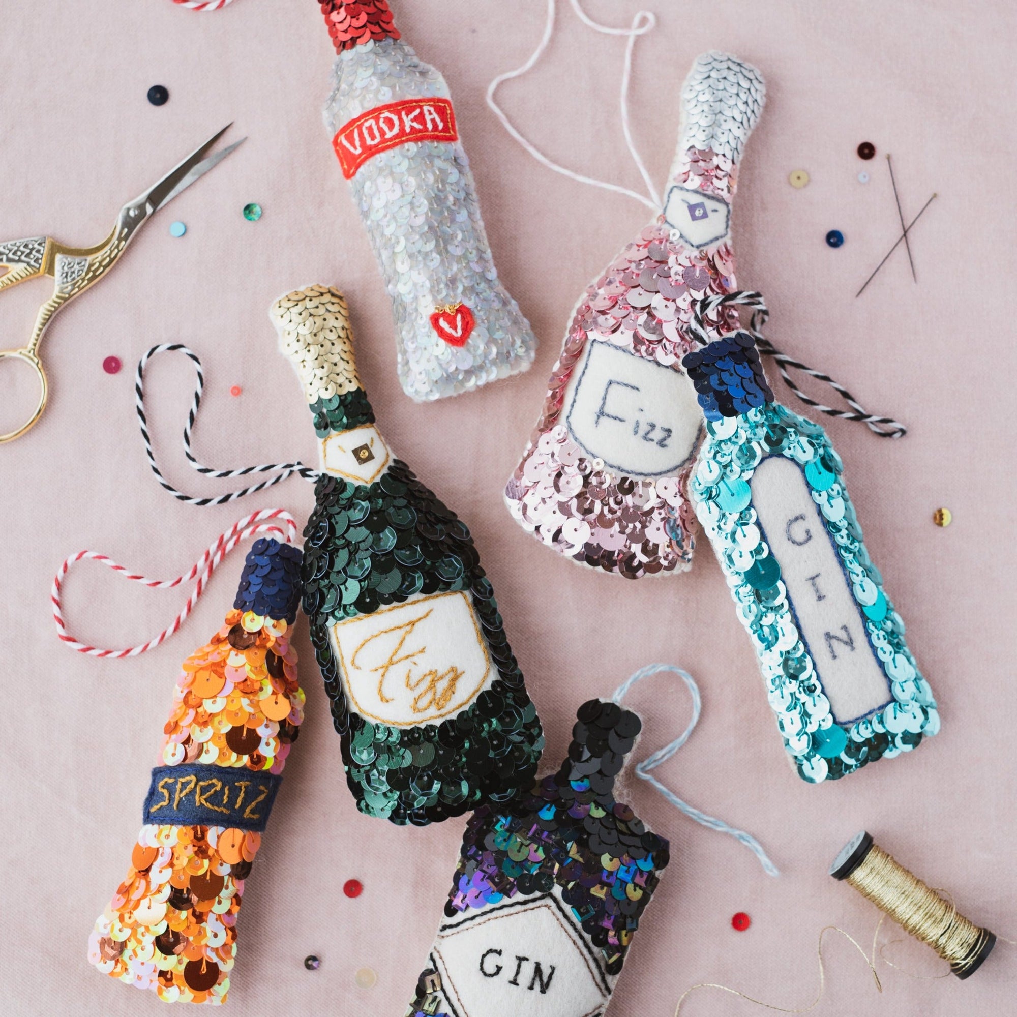a collection of sequinned ornaments, including a spritz, gin, vodka and champagne