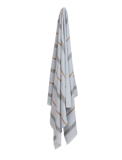Pale blue towel with black and tan stripes hanging on a wall. 