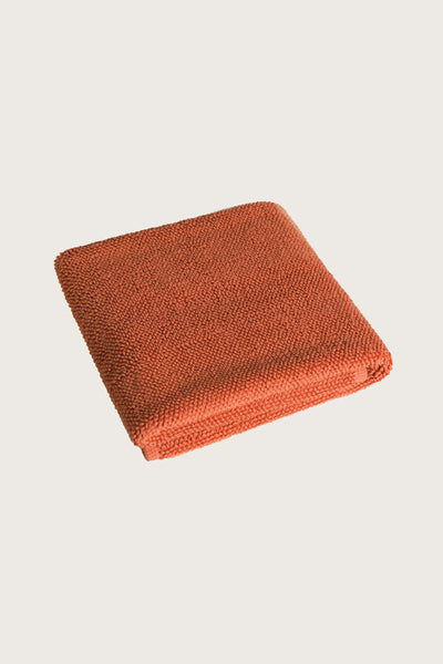 Købn Tamarillo Bathmat folded with a plush pile chunky cotton weave. Sustainably made in Turkey. 