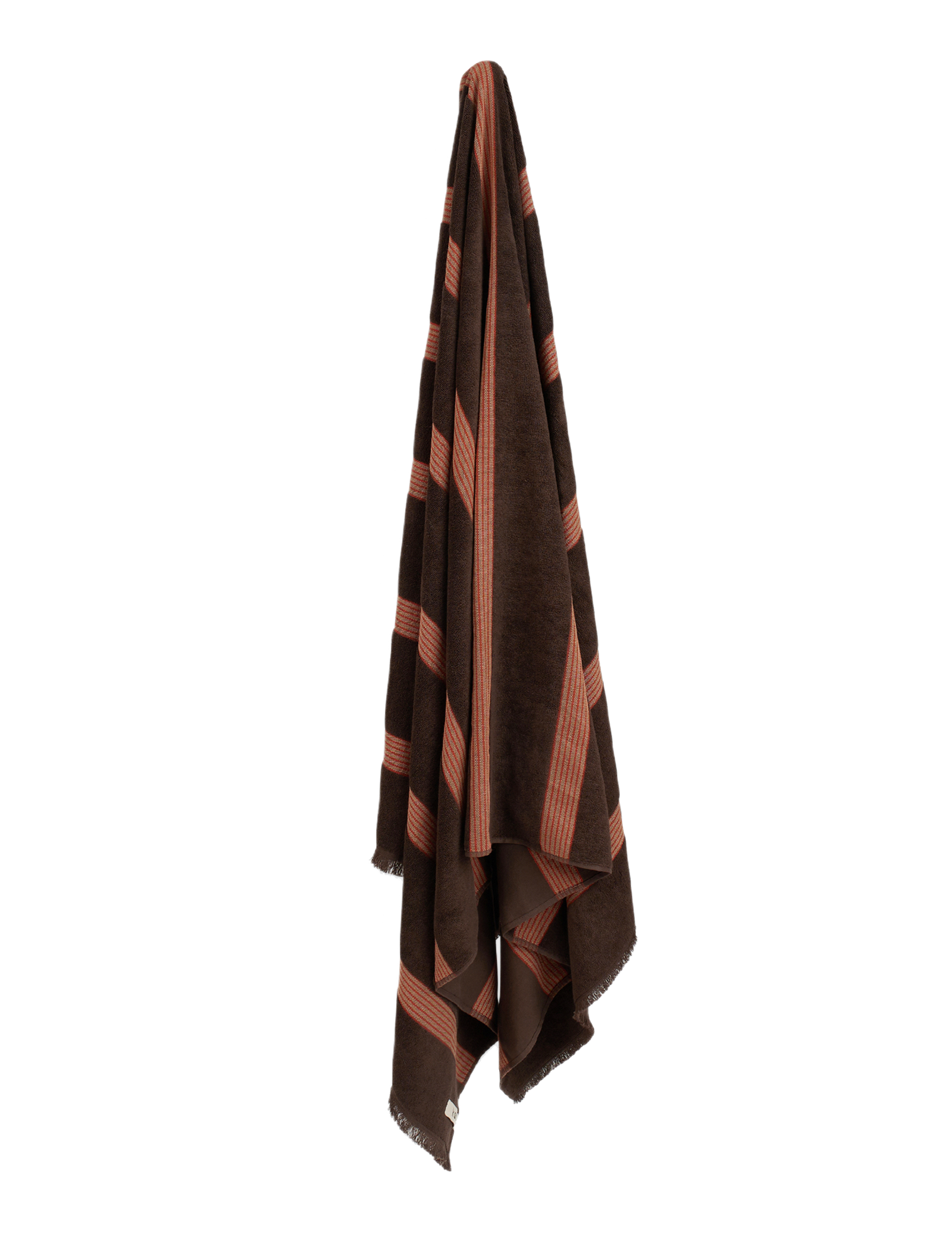 Dark brown towel with red stripes hanging on blank wall.