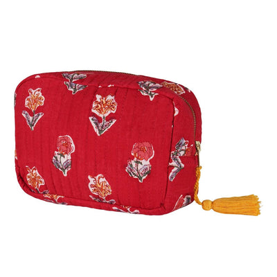 A red hand block-printed vanity pouch with floral patterns, crafted from cotton, with a yellow tassel on the zip.