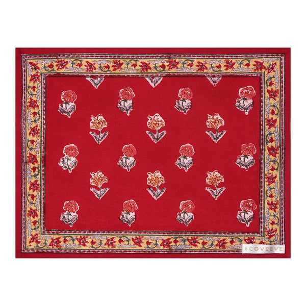 A hand-block printed red cotton table mat with floral patterns and a border.