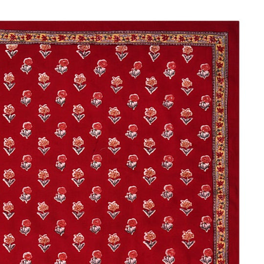 A red floral block printed tablecloth with a border
