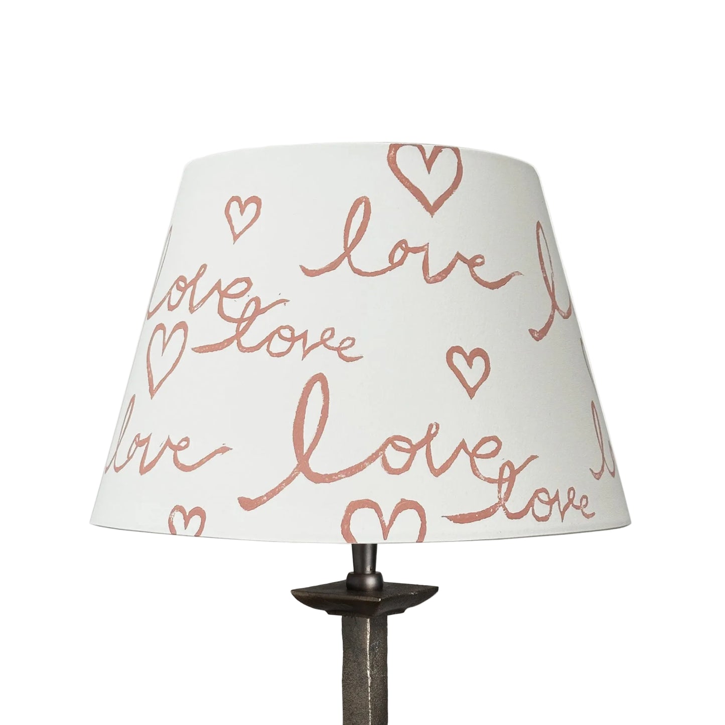 Cut out image of a handmade empire lampshade with a block-printed design featuring the handwritten word "love" and heart motifs. The cream card lampshade has a modern, romantic aesthetic.