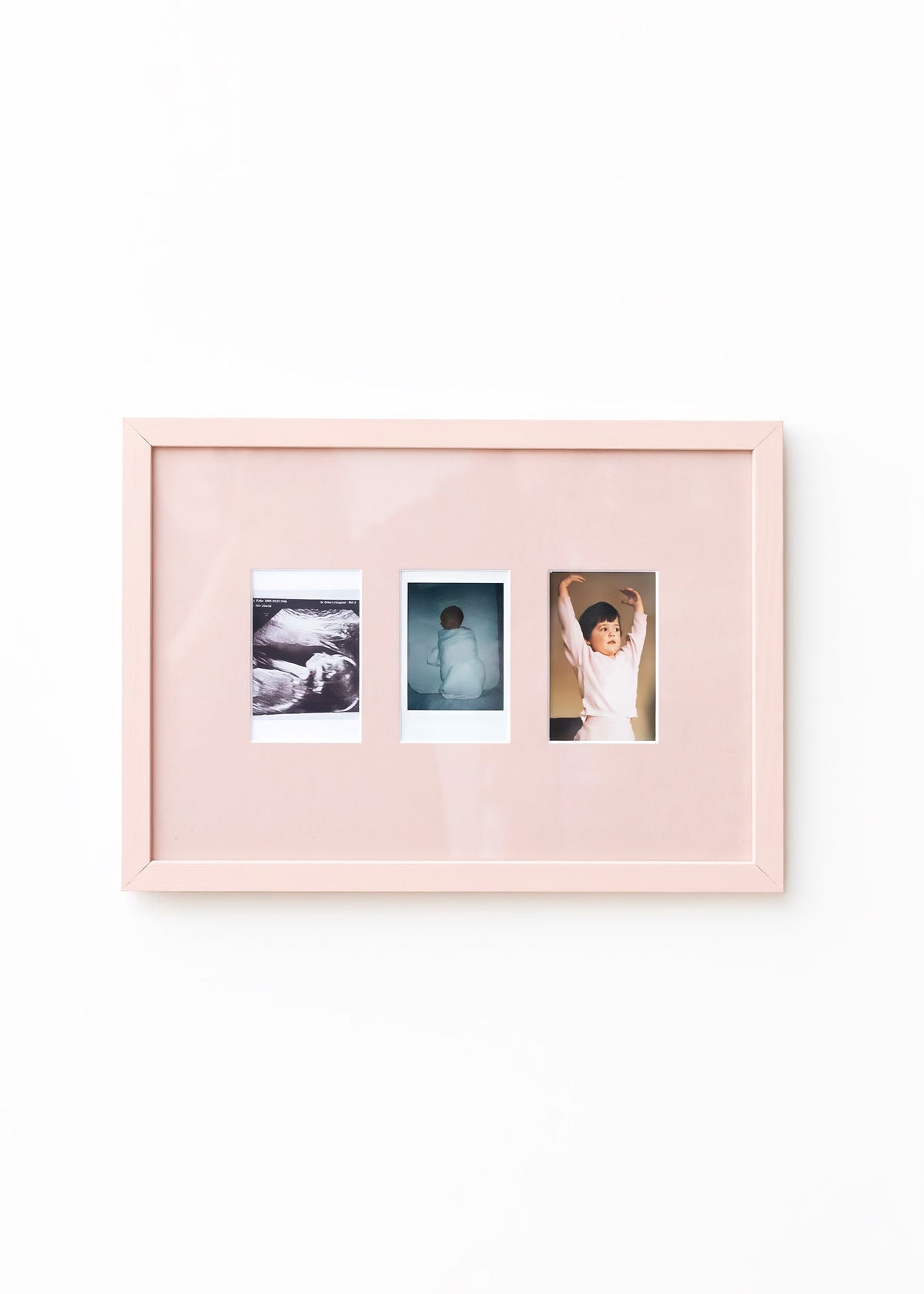 A light pink double-photo frame with a glossy finish, displaying two sample photographs side-by-side against a clean white background.