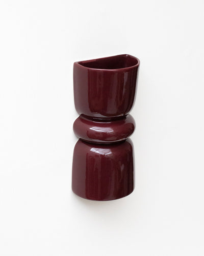 Late Afternoon Lighting Burgundy Up and Down lighter Ceramic Wall Light hung on a white wall