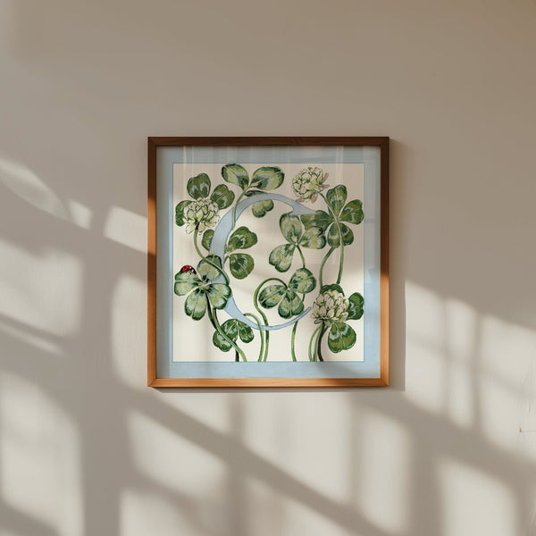 Framed botanical artwork of leaves and flowers on a beige wall for nurseries.