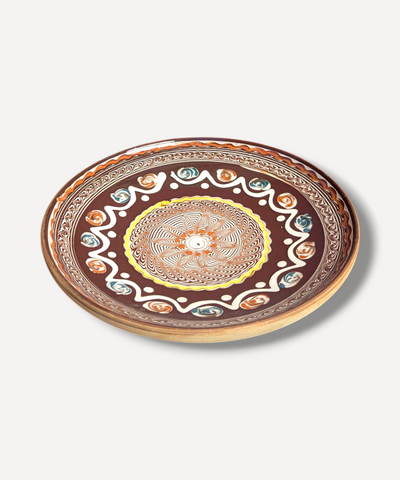 Decorative plate with a colorful mandala design on a white background