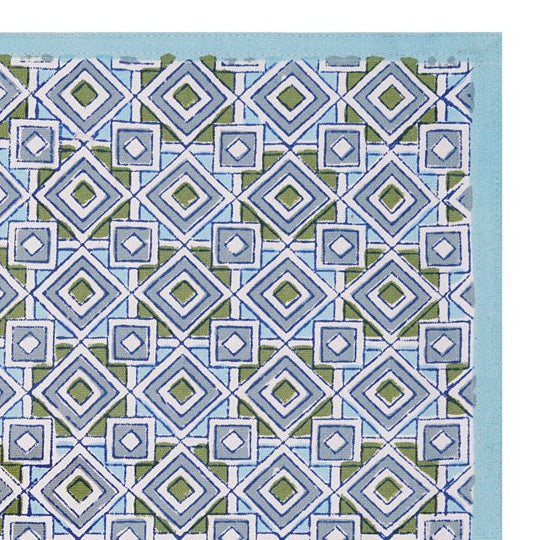A hand-block printed blue cotton table mat with a geometric pattern.