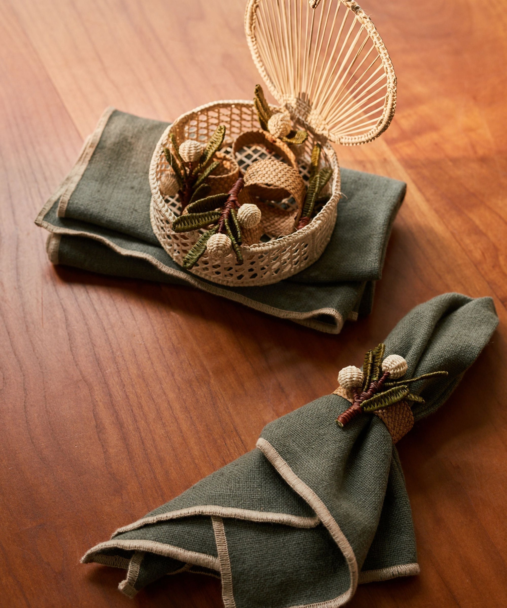 Mistletoe napkin ring, handwoven iraca palm, on a festive table setting