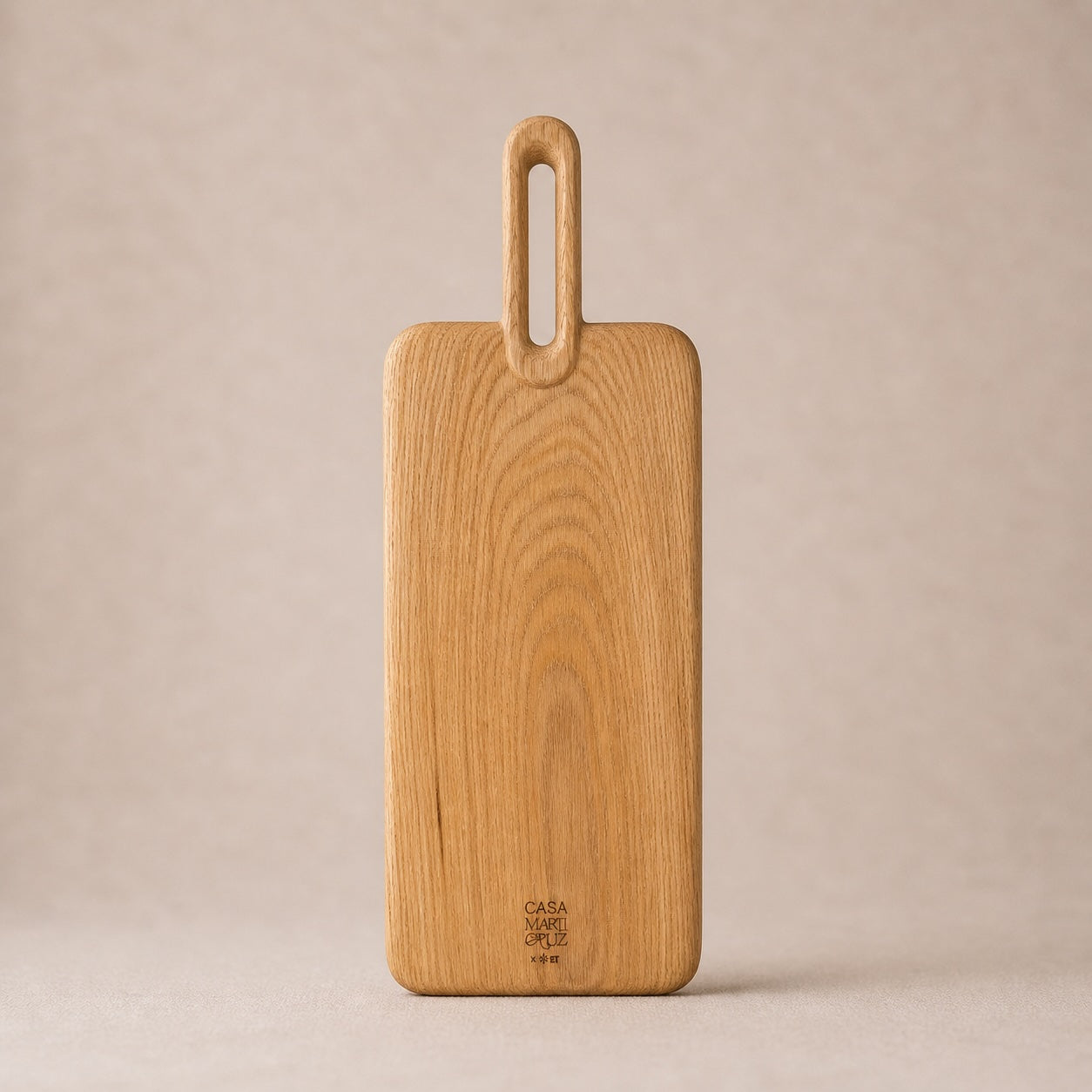 Wooden cutting board with handle on a beige background