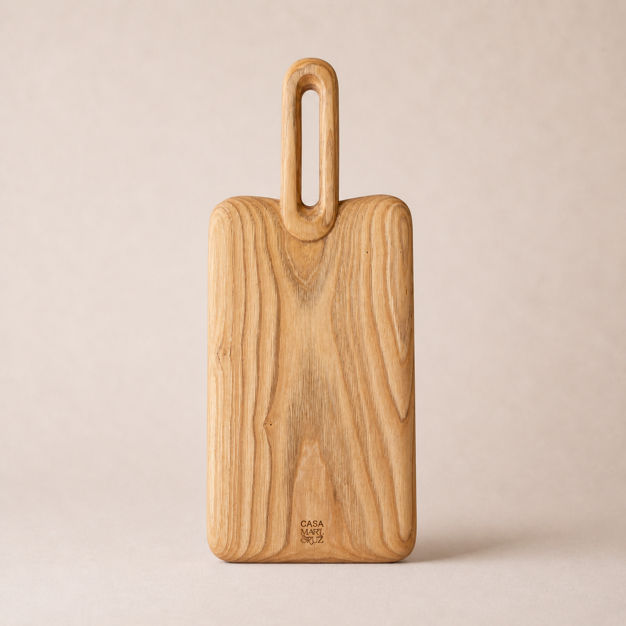 Wooden cutting board with handle on a beige background