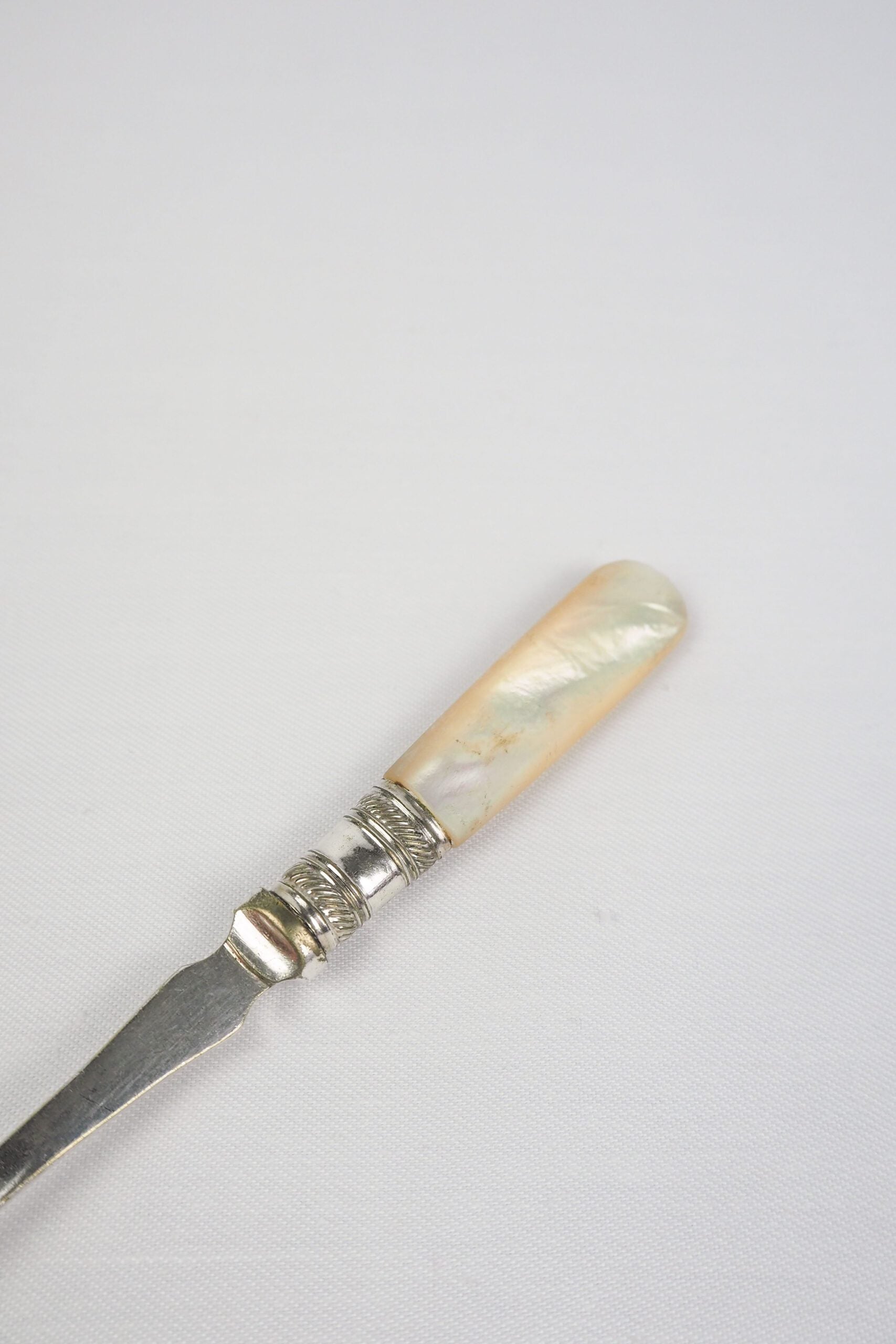 This Antique Pickle Fork is the perfect piece for your kitchen. With a beautiful Mother of Pearl handle and a Silver Plated neck and barbed prongs. Wildmore