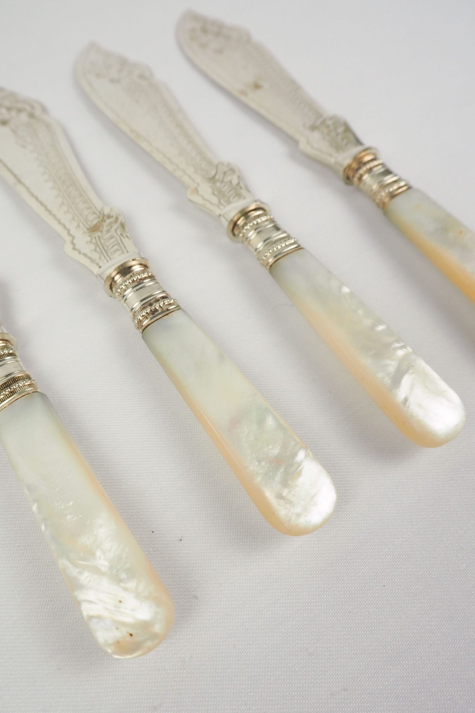 A Set of 4 Antique Silver Plate Fish Knives with mother of pearl handles. The blade of each Victorian Fish Knife has a beautifully etched floral pattern. Wildmore