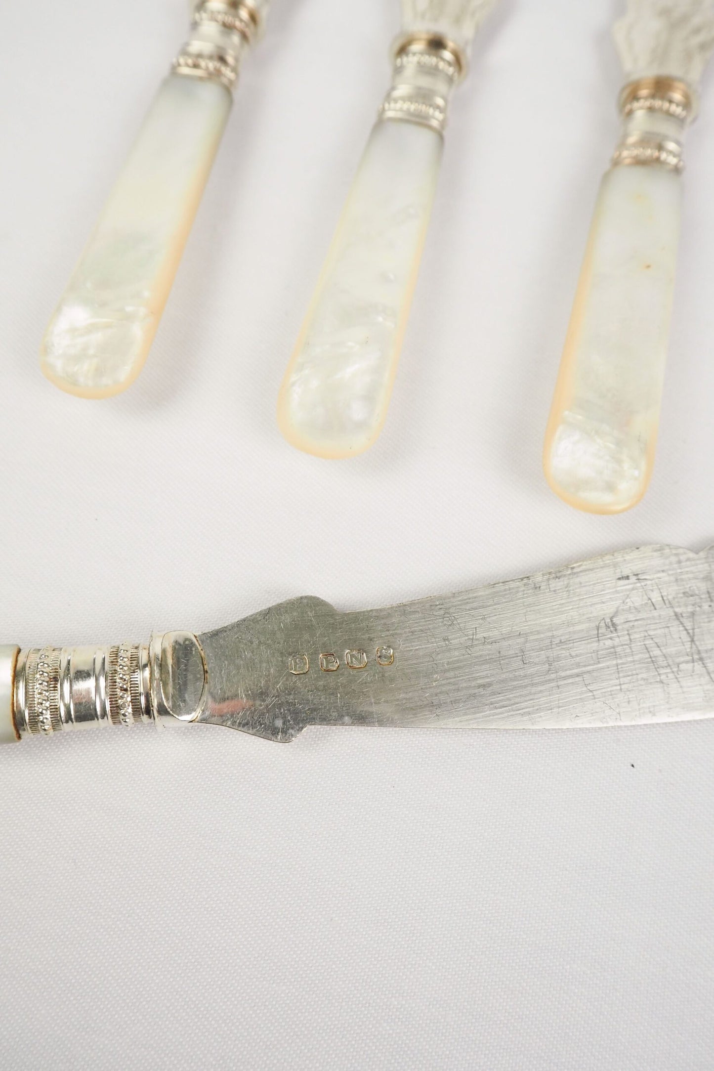 A Set of 4 Antique Silver Plate Fish Knives with mother of pearl handles. The blade of each Victorian Fish Knife has a beautifully etched floral pattern. Wildmore