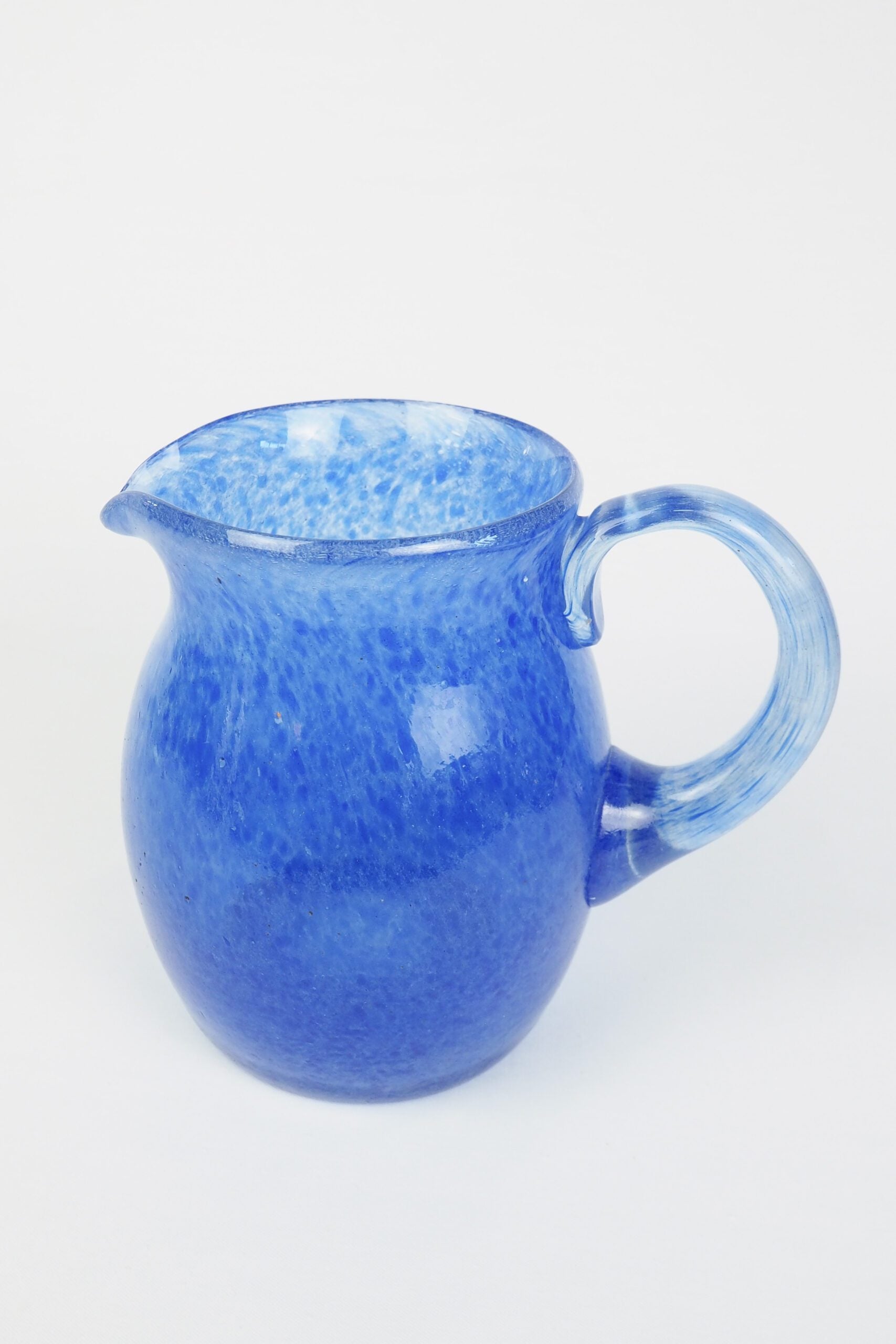A hand blown Vintage Gass Jug with a blue speckle pattern and bubbles running through the glass. Wildmore