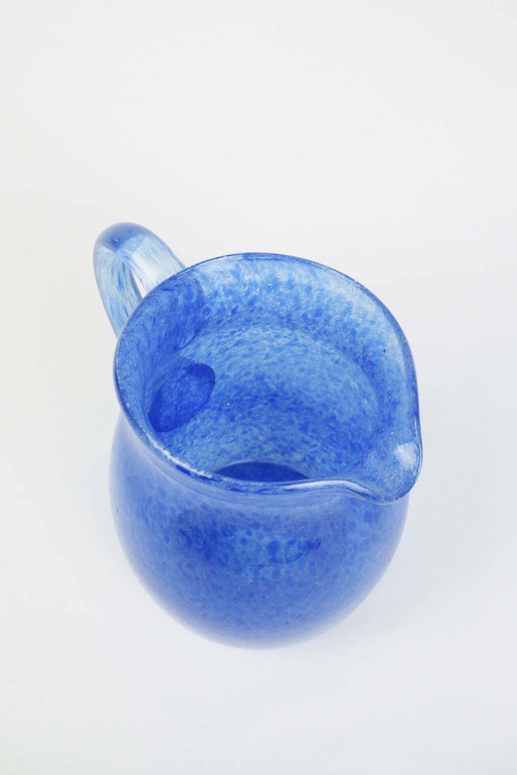 A hand blown Vintage Gass Jug with a blue speckle pattern and bubbles running through the glass. Wildmore