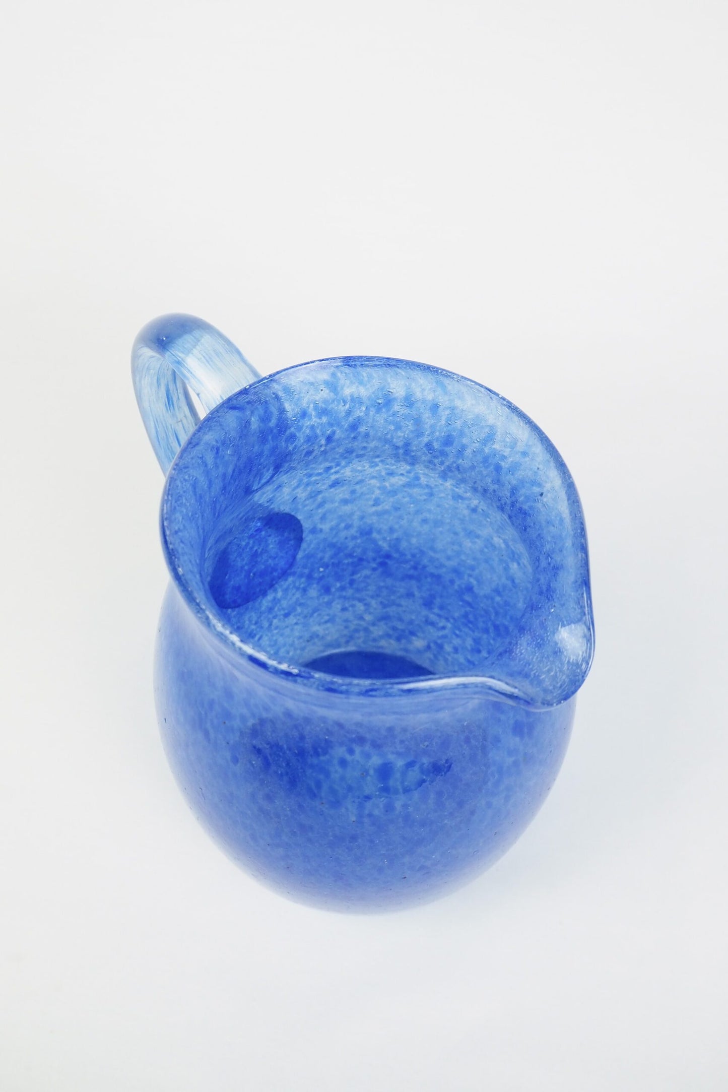 A hand blown Vintage Gass Jug with a blue speckle pattern and bubbles running through the glass. Wildmore