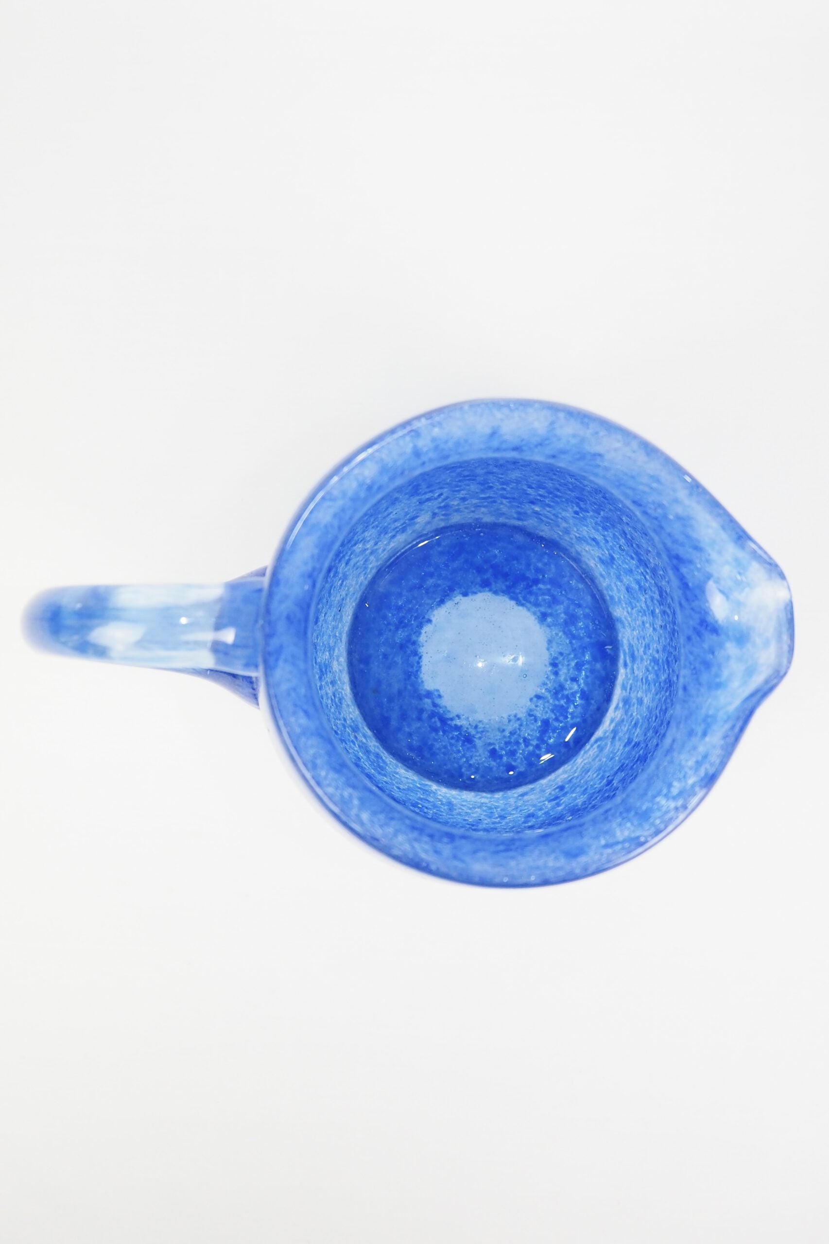 A hand blown Vintage Gass Jug with a blue speckle pattern and bubbles running through the glass. Wildmore