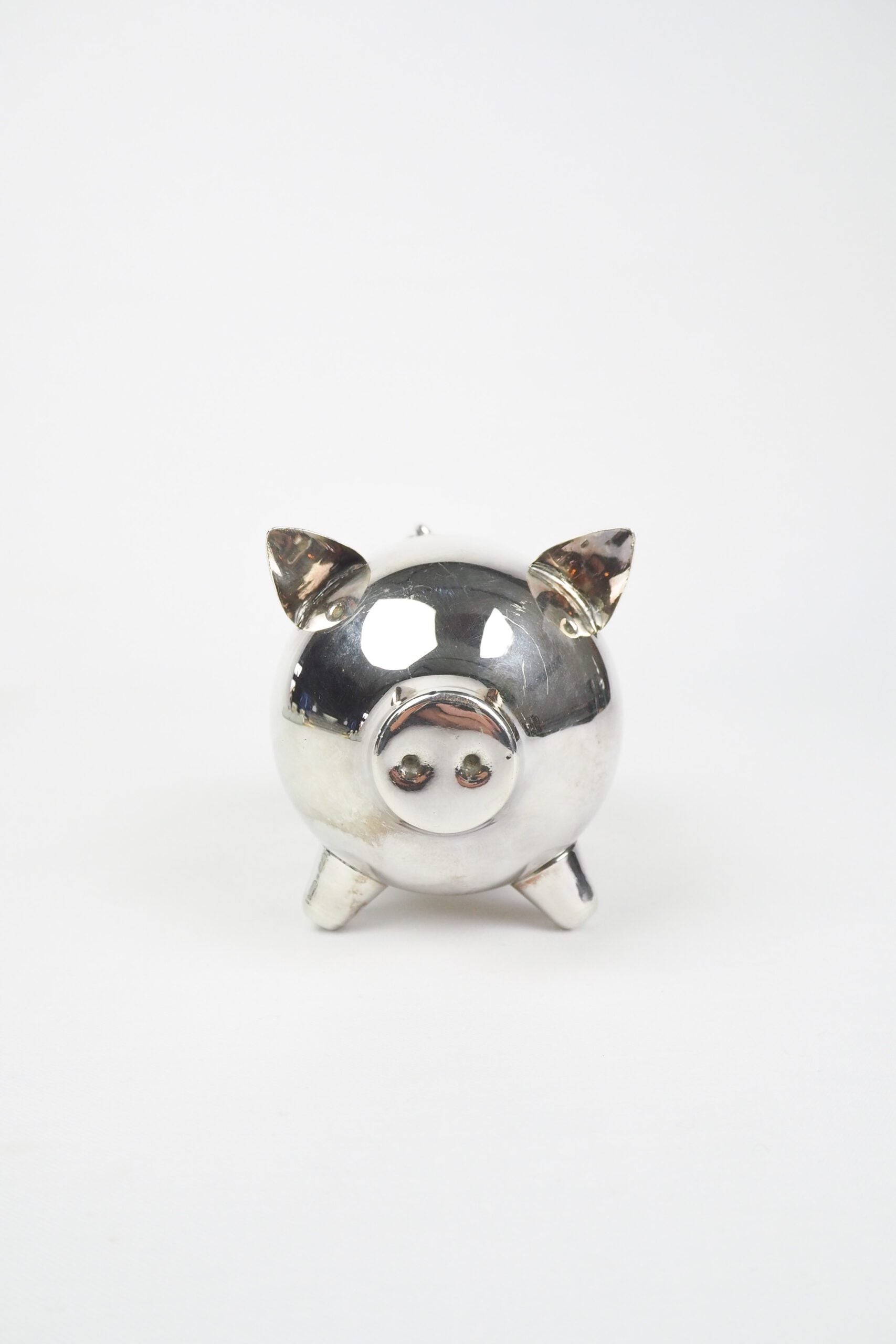 A wonderful Vintage Silver Plate Piggy Bank. This silver plated pig money box has a little curly tail and expressive ears. Wildmore