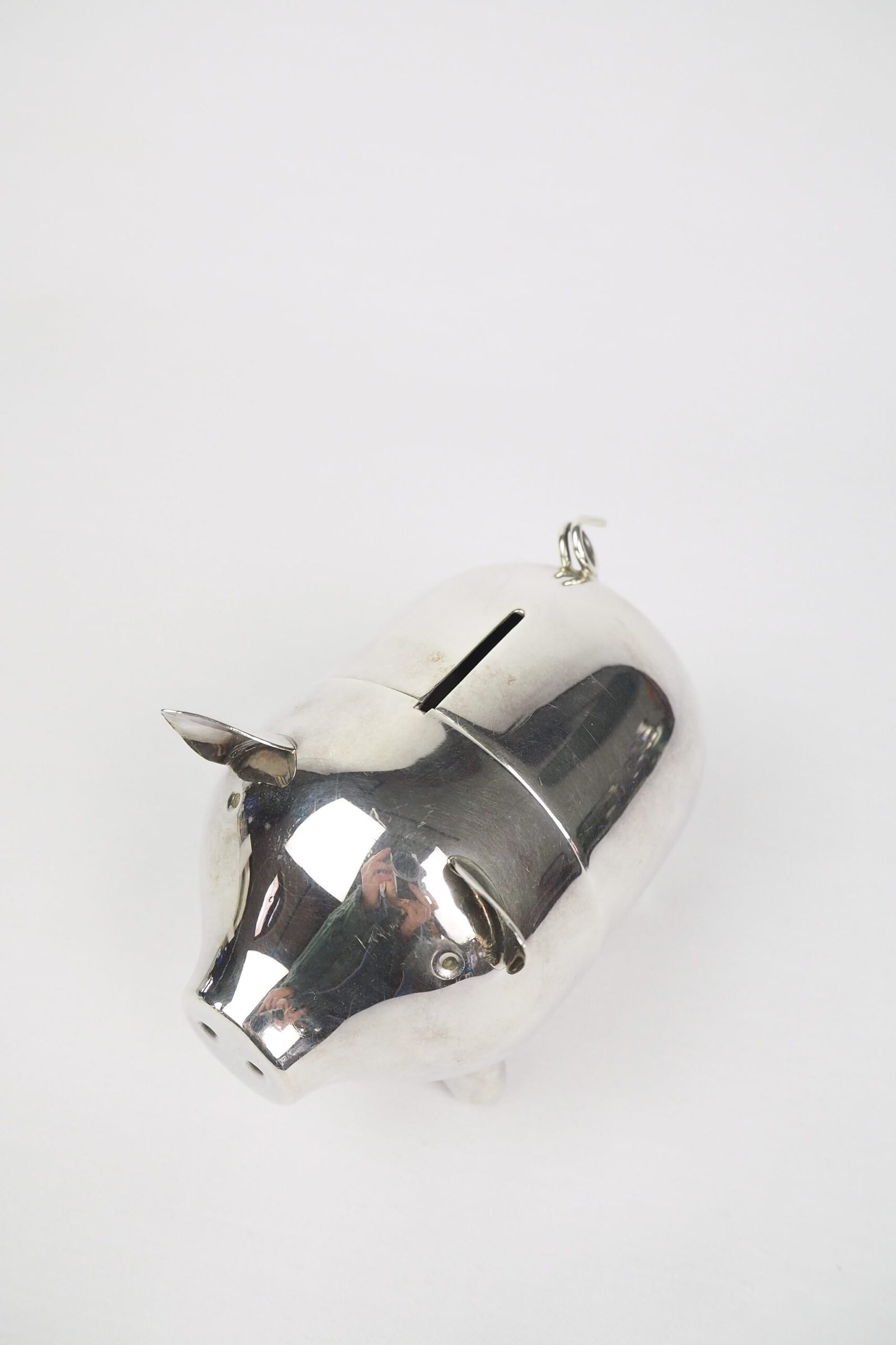 A wonderful Vintage Silver Plate Piggy Bank. This silver plated pig money box has a little curly tail and expressive ears. Wildmore