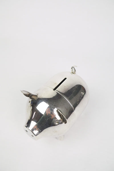 A wonderful Vintage Silver Plate Piggy Bank. This silver plated pig money box has a little curly tail and expressive ears. Wildmore