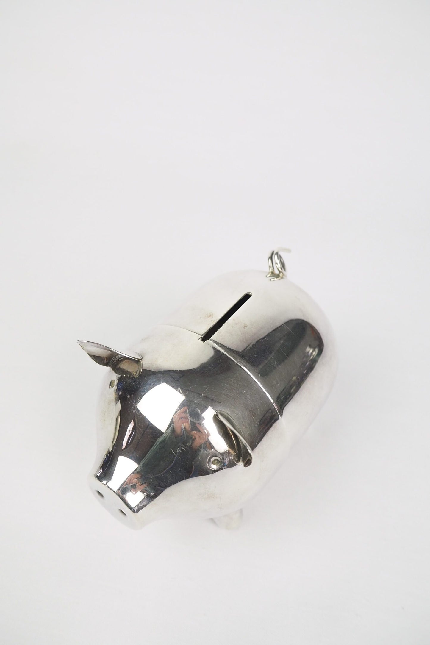 A wonderful Vintage Silver Plate Piggy Bank. This silver plated pig money box has a little curly tail and expressive ears. Wildmore