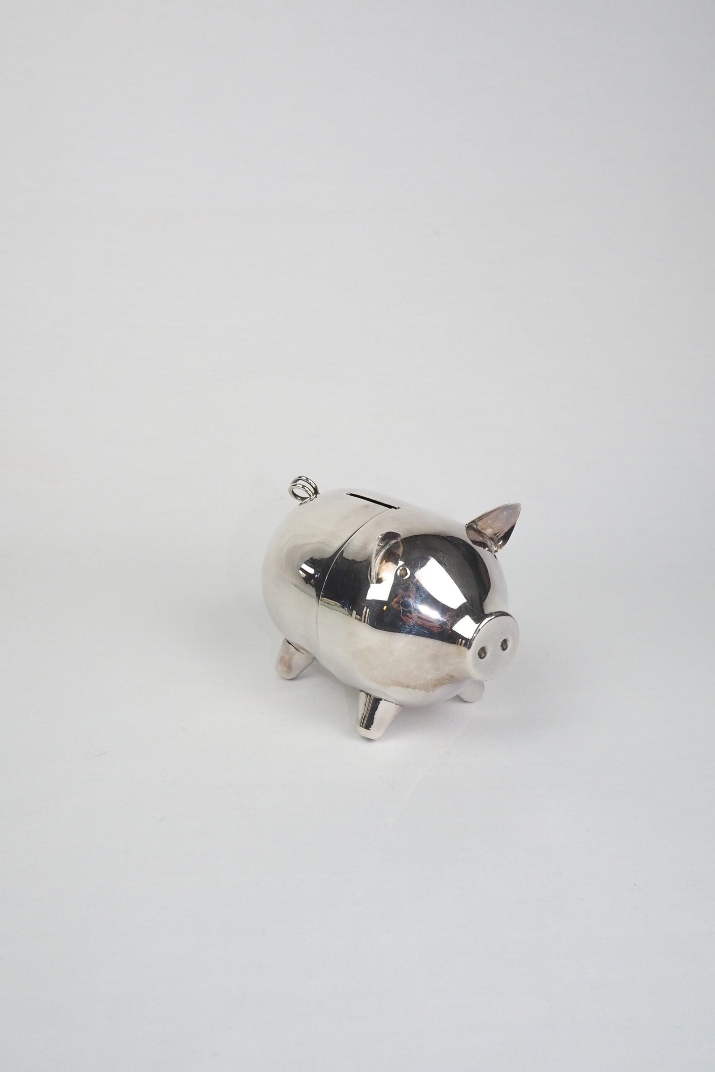 A wonderful Vintage Silver Plate Piggy Bank. This silver plated pig money box has a little curly tail and expressive ears. Wildmore