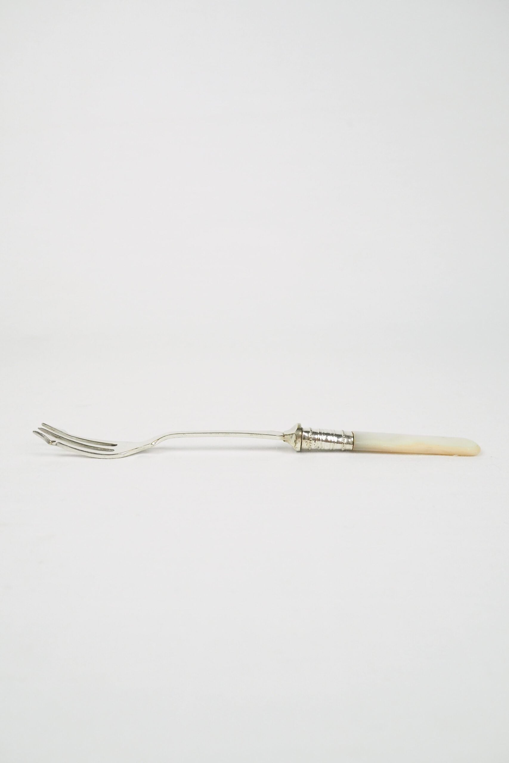 This Antique Pickle Fork has a beautiful Mother of Pearl handle, a Silver Plated neck and barbed prongs. Wildmore