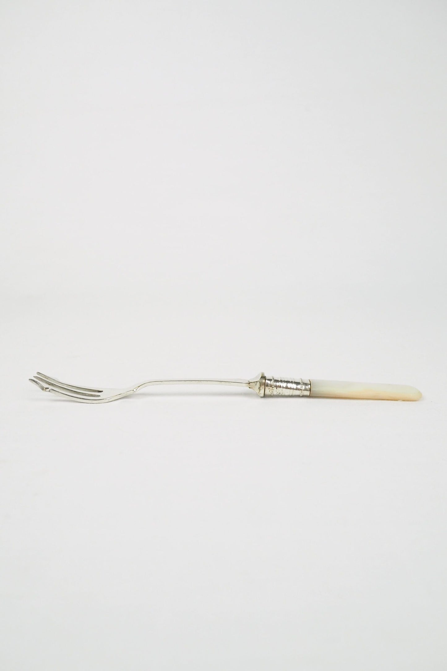 This Antique Pickle Fork has a beautiful Mother of Pearl handle, a Silver Plated neck and barbed prongs. Wildmore