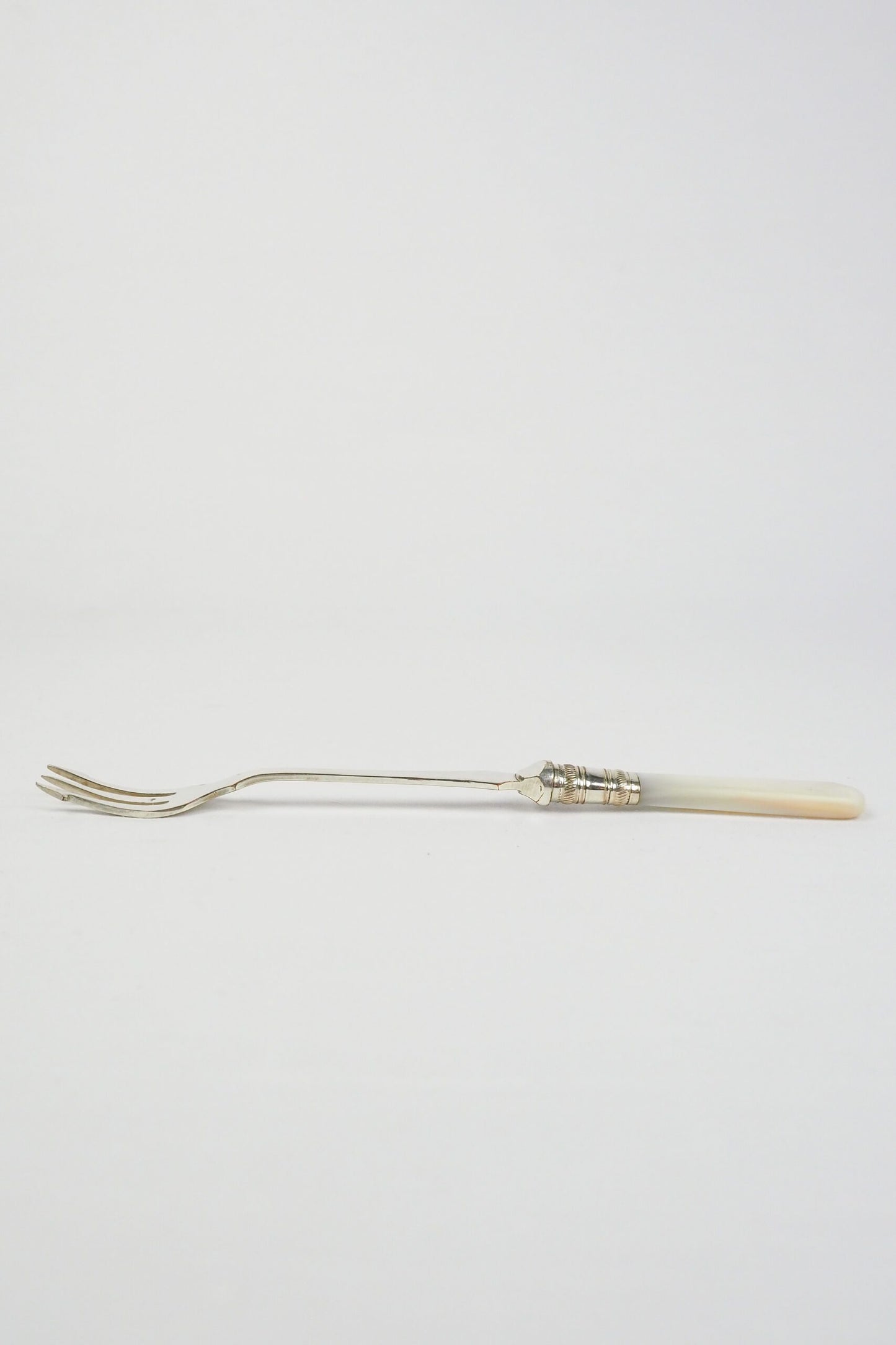 This Antique Pickle Fork has a beautiful Mother of Pearl handle, a Silver Plated neck and barbed prongs. Wildmore