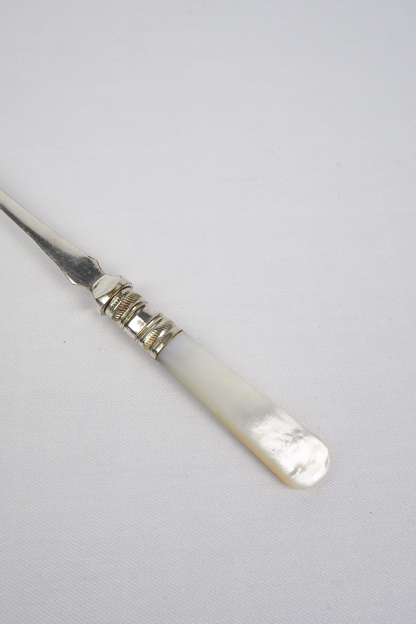 This Antique Pickle Fork has a beautiful Mother of Pearl handle, a Silver Plated neck and barbed prongs. Wildmore