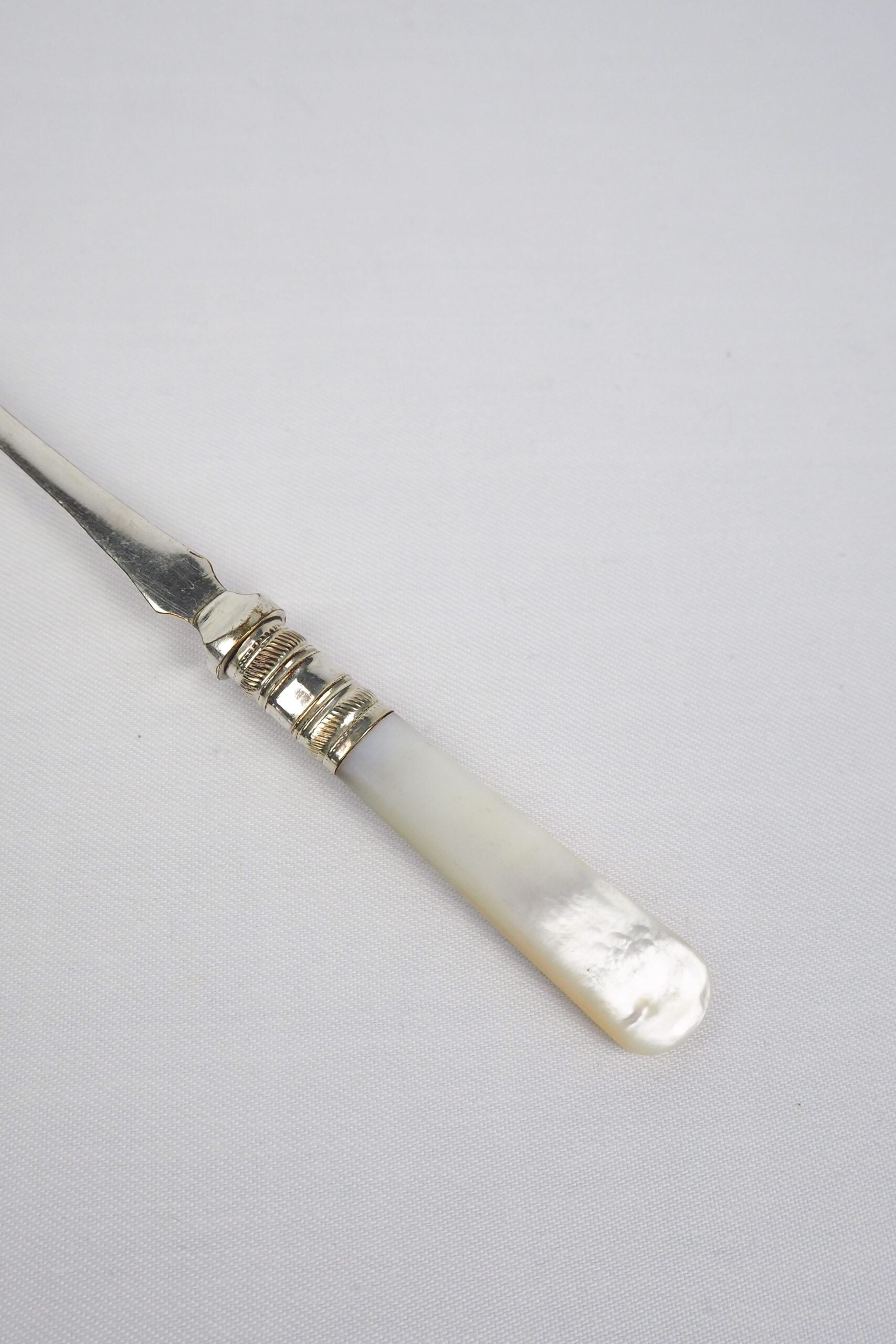 This Antique Pickle Fork has a beautiful Mother of Pearl handle, a Silver Plated neck and barbed prongs. Wildmore