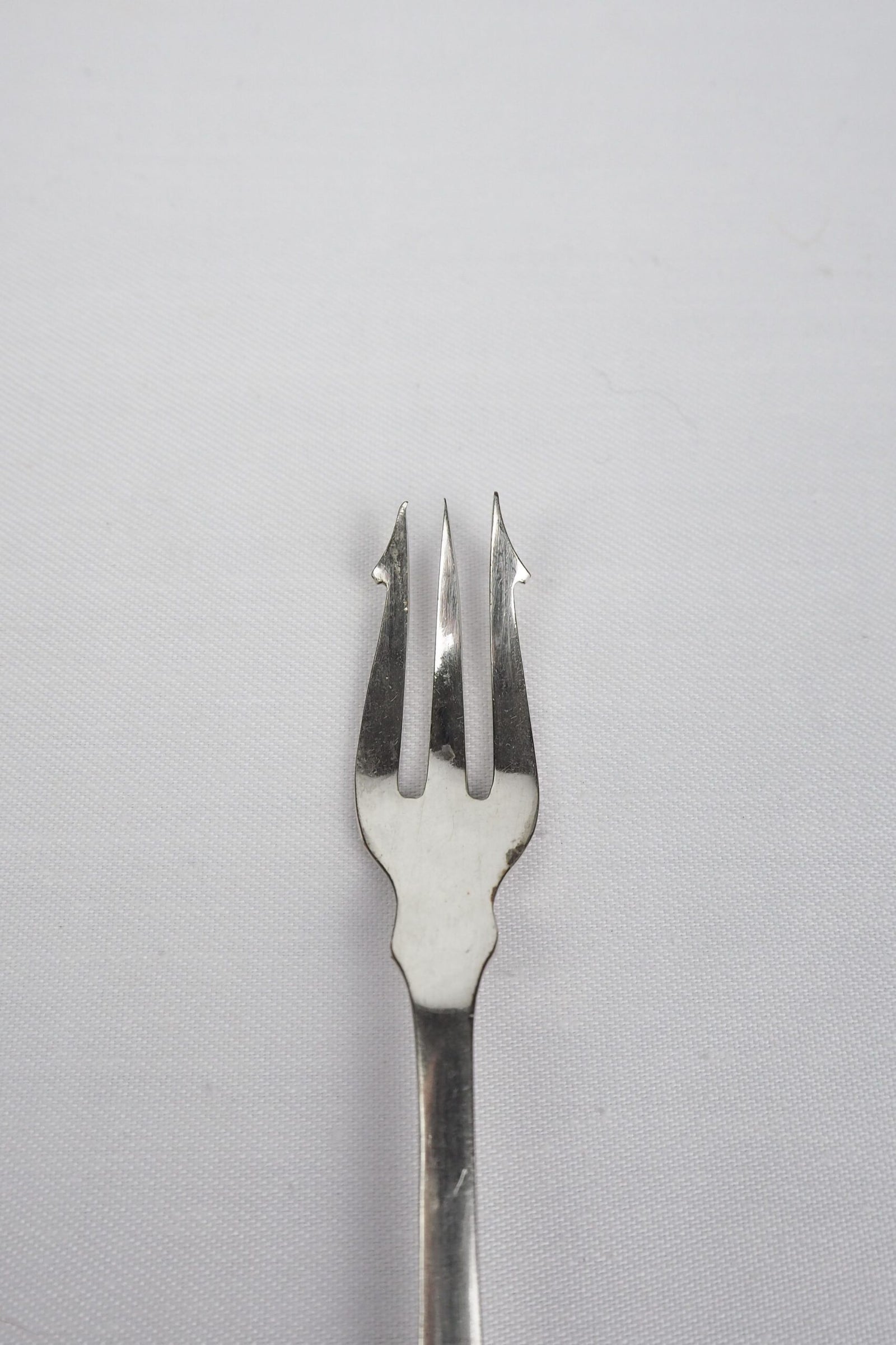 This Antique Pickle Fork has a beautiful Mother of Pearl handle, a Silver Plated neck and barbed prongs. Wildmore