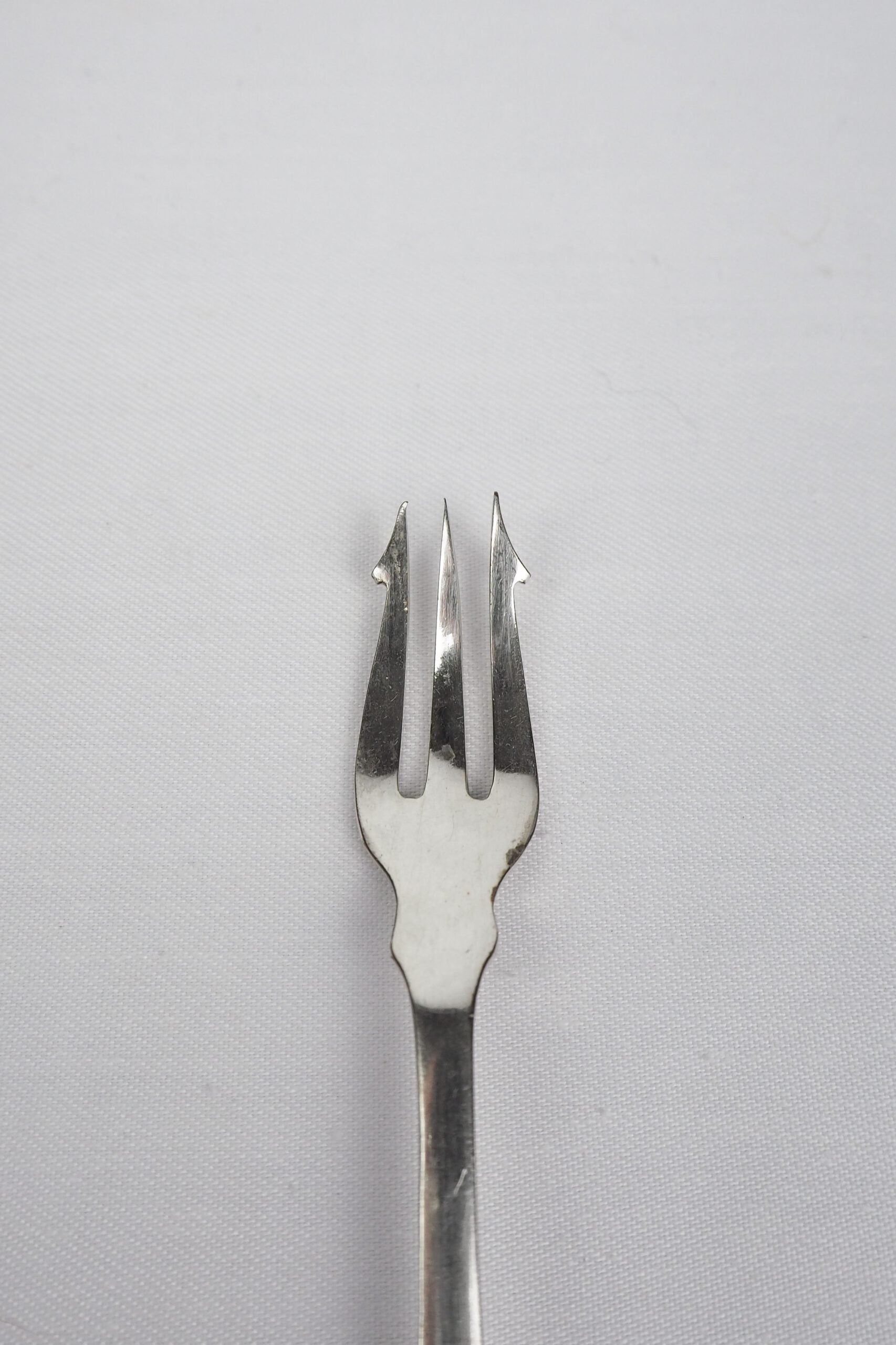 This Antique Pickle Fork has a beautiful Mother of Pearl handle, a Silver Plated neck and barbed prongs. Wildmore