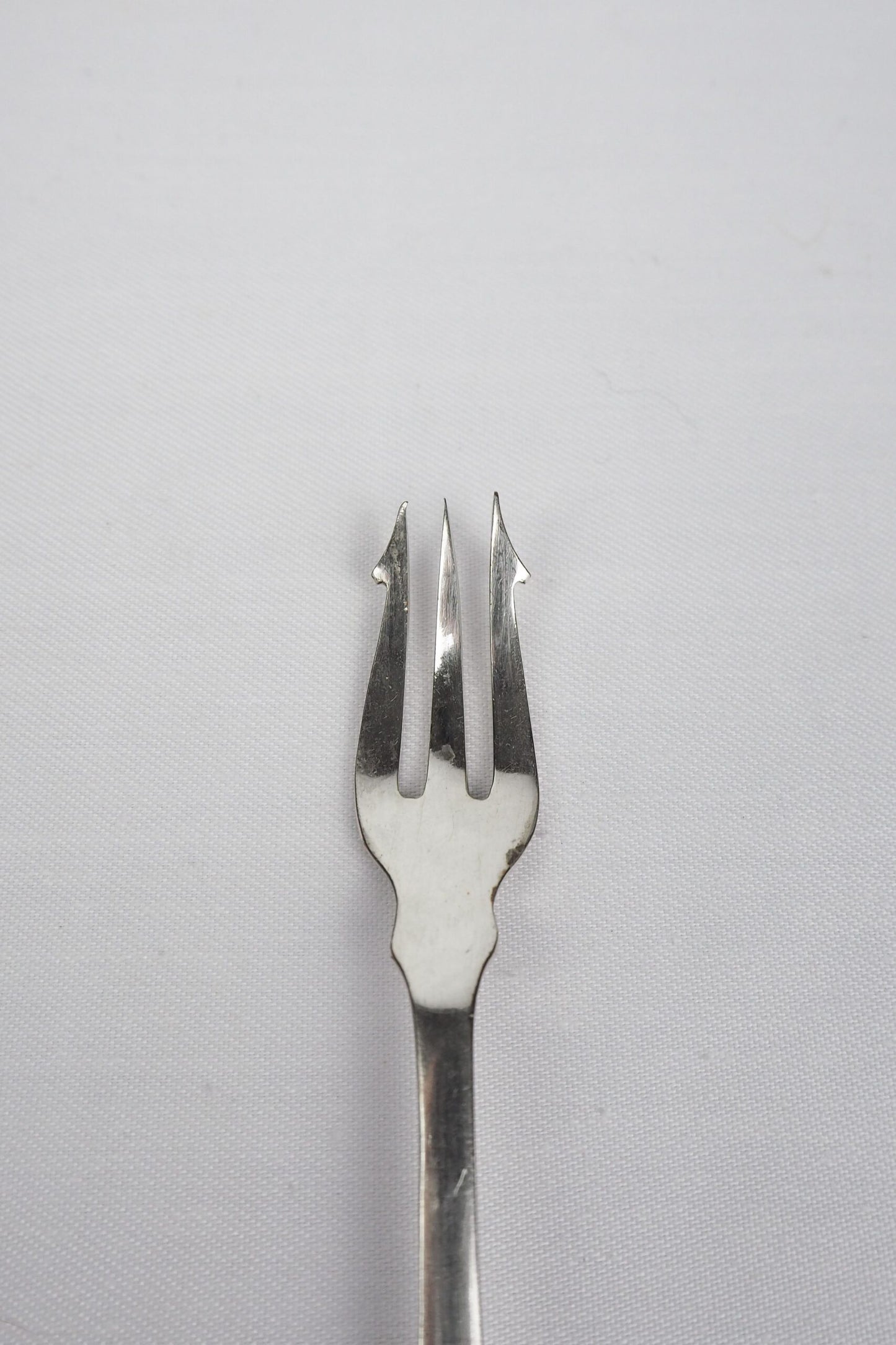 This Antique Pickle Fork has a beautiful Mother of Pearl handle, a Silver Plated neck and barbed prongs. Wildmore