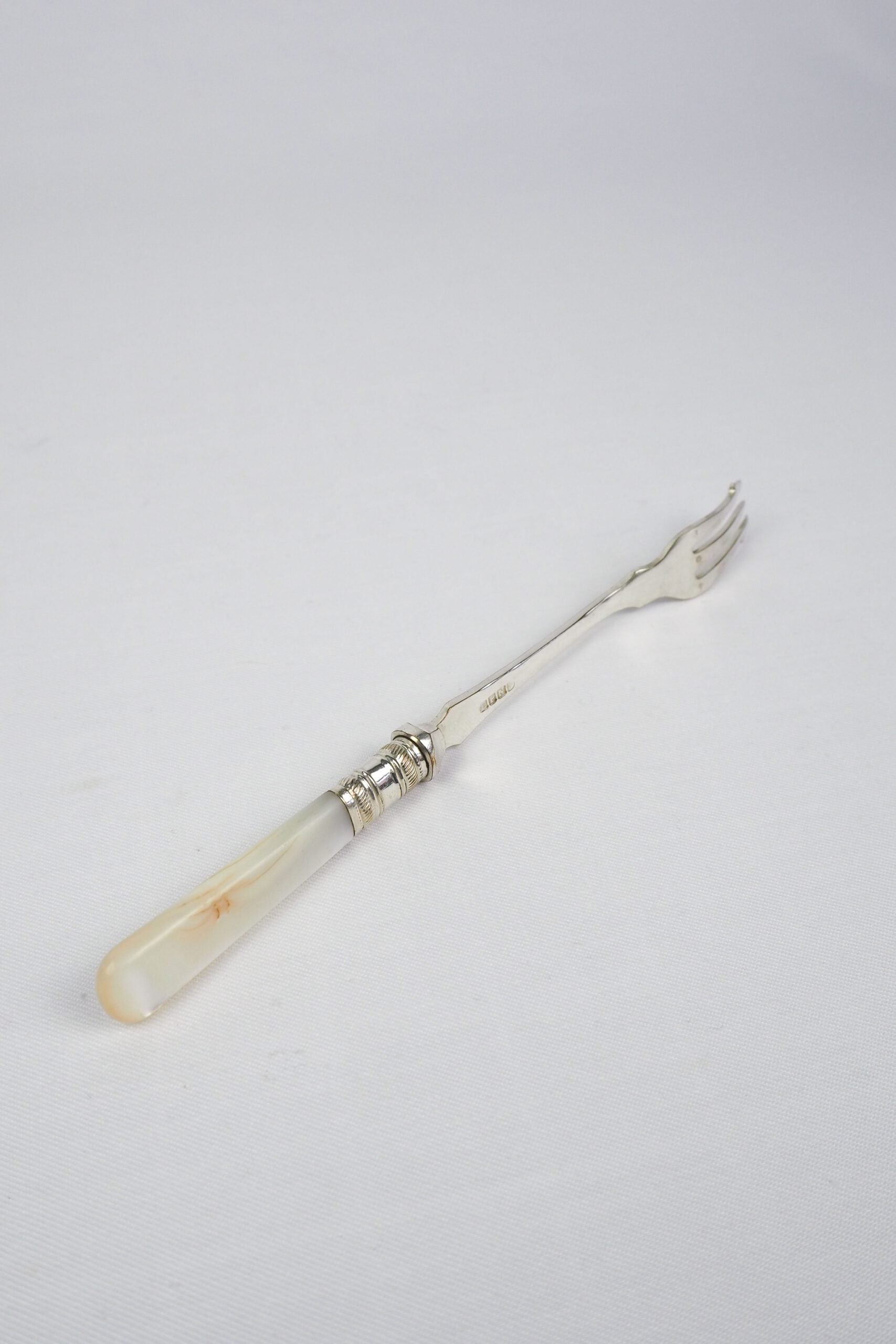 This Antique Pickle Fork has a beautiful Mother of Pearl handle, a Silver Plated neck and barbed prongs. Wildmore