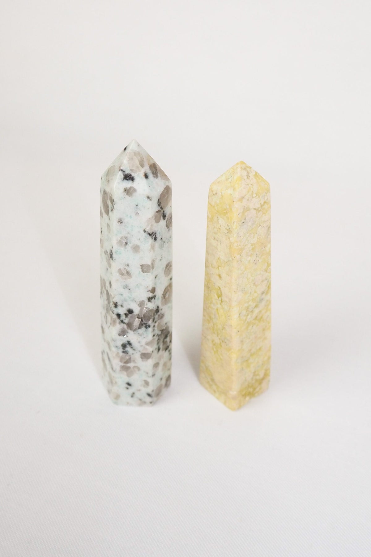 A decorative Pair of Mineral Obelisks including a Kiwi Jasper and a Serpentine Tower.