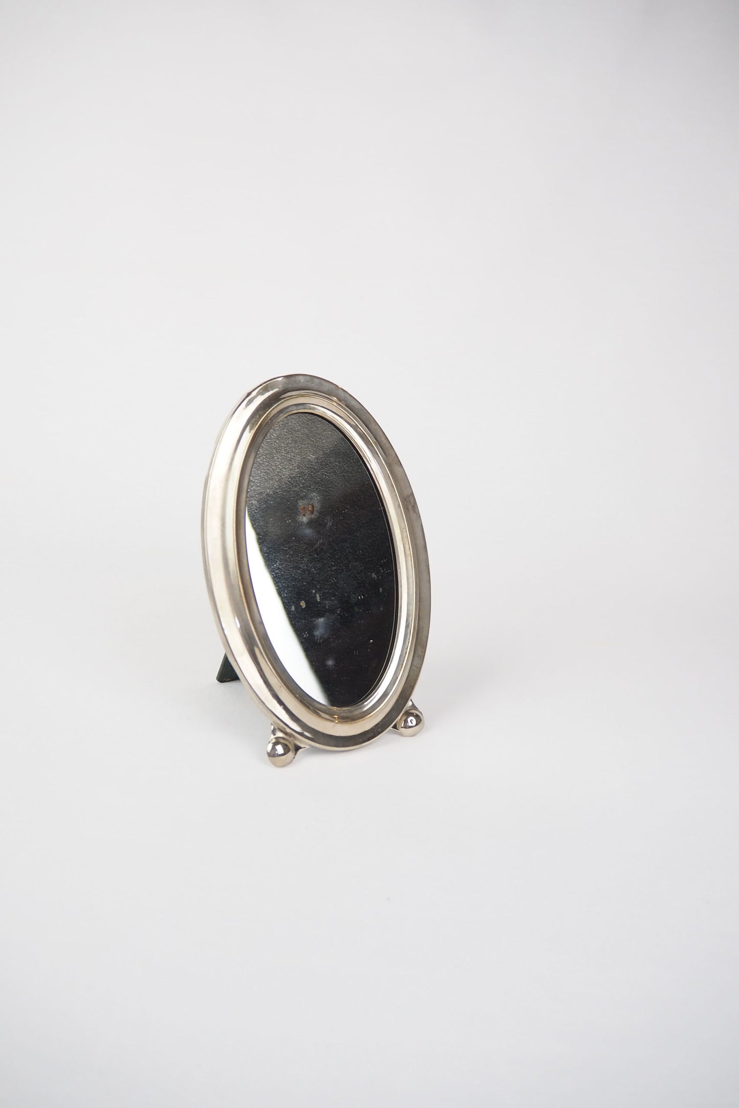An Antique Silver Plate Framed Mirror. This antique silver plate mirror is perfect for your mantelpiece.
