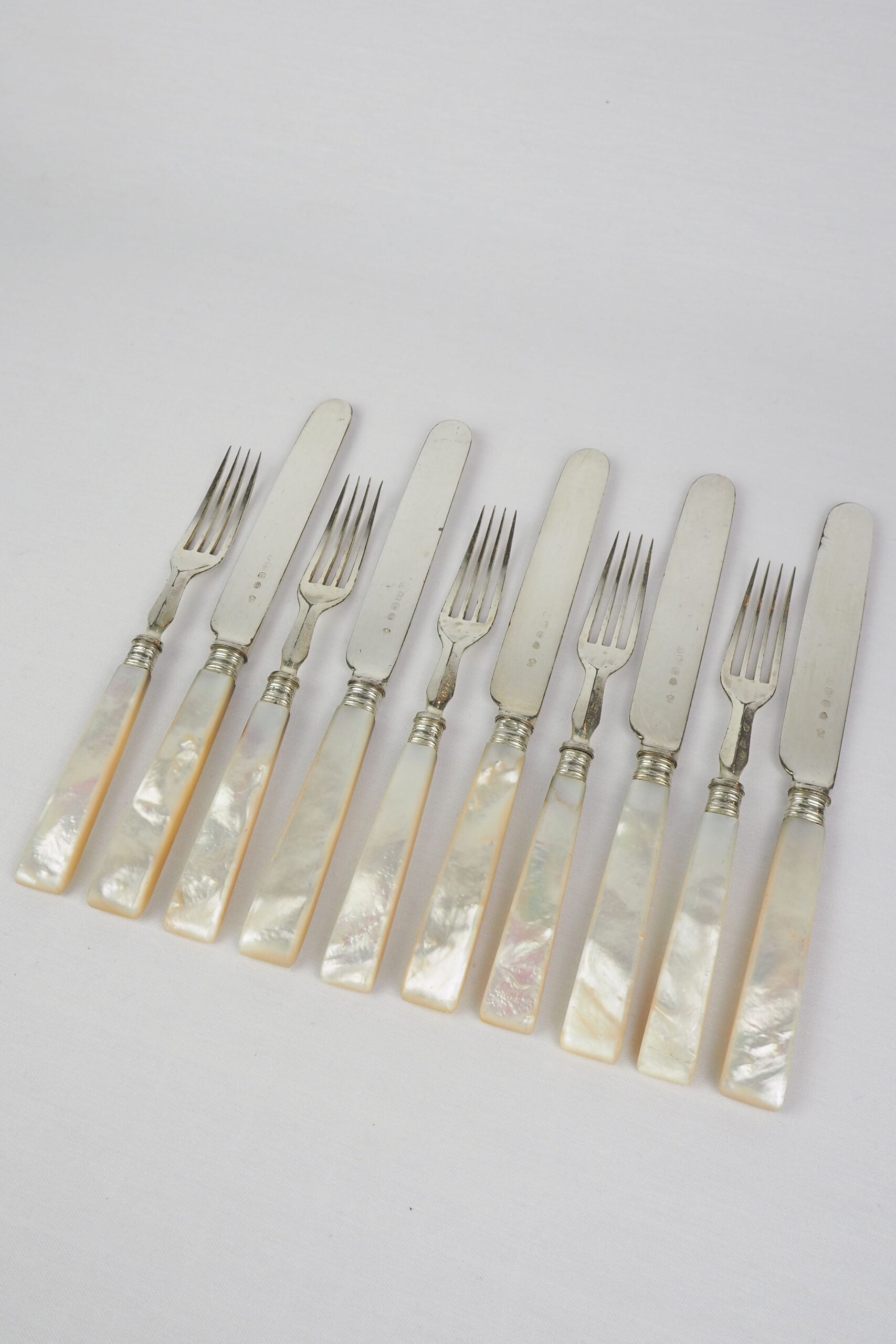 10 piece Antique Mother of Pearl Cutlery Set. The aged silver plate and mother of pearl handles give this set of knives and forks an antique look