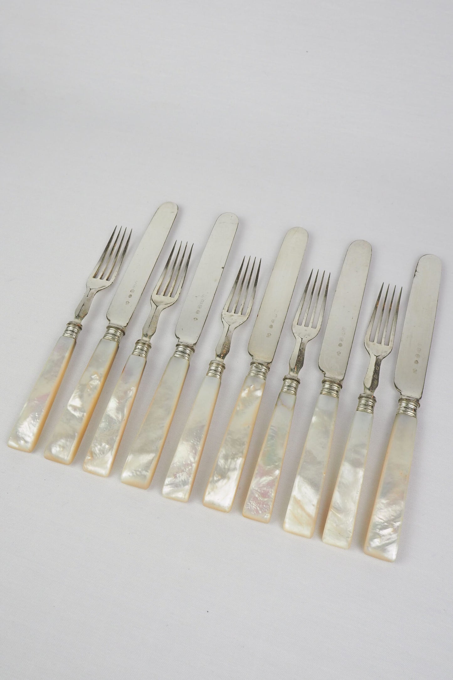 10 piece Antique Mother of Pearl Cutlery Set. The aged silver plate and mother of pearl handles give this set of knives and forks an antique look