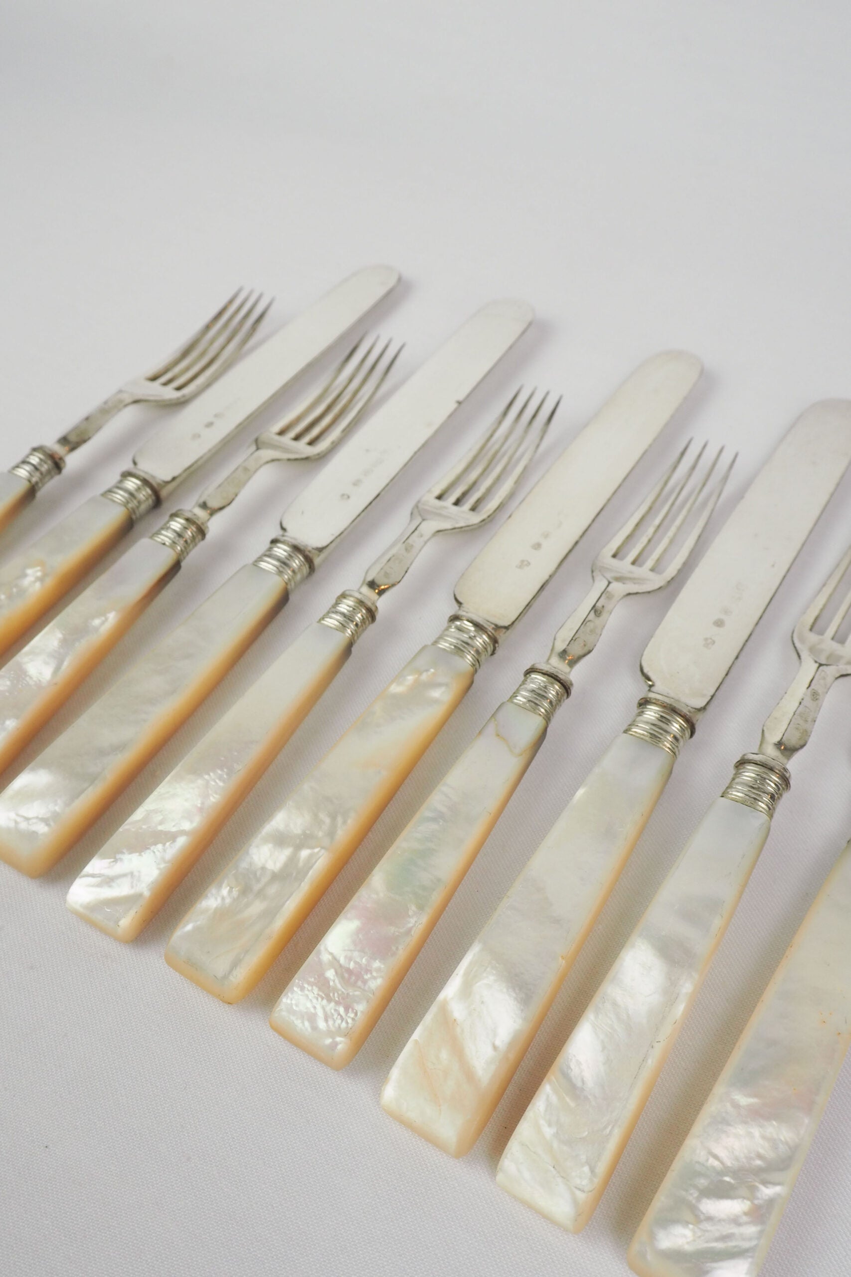 10 piece Antique Mother of Pearl Cutlery Set. The aged silver plate and mother of pearl handles give this set of knives and forks an antique look