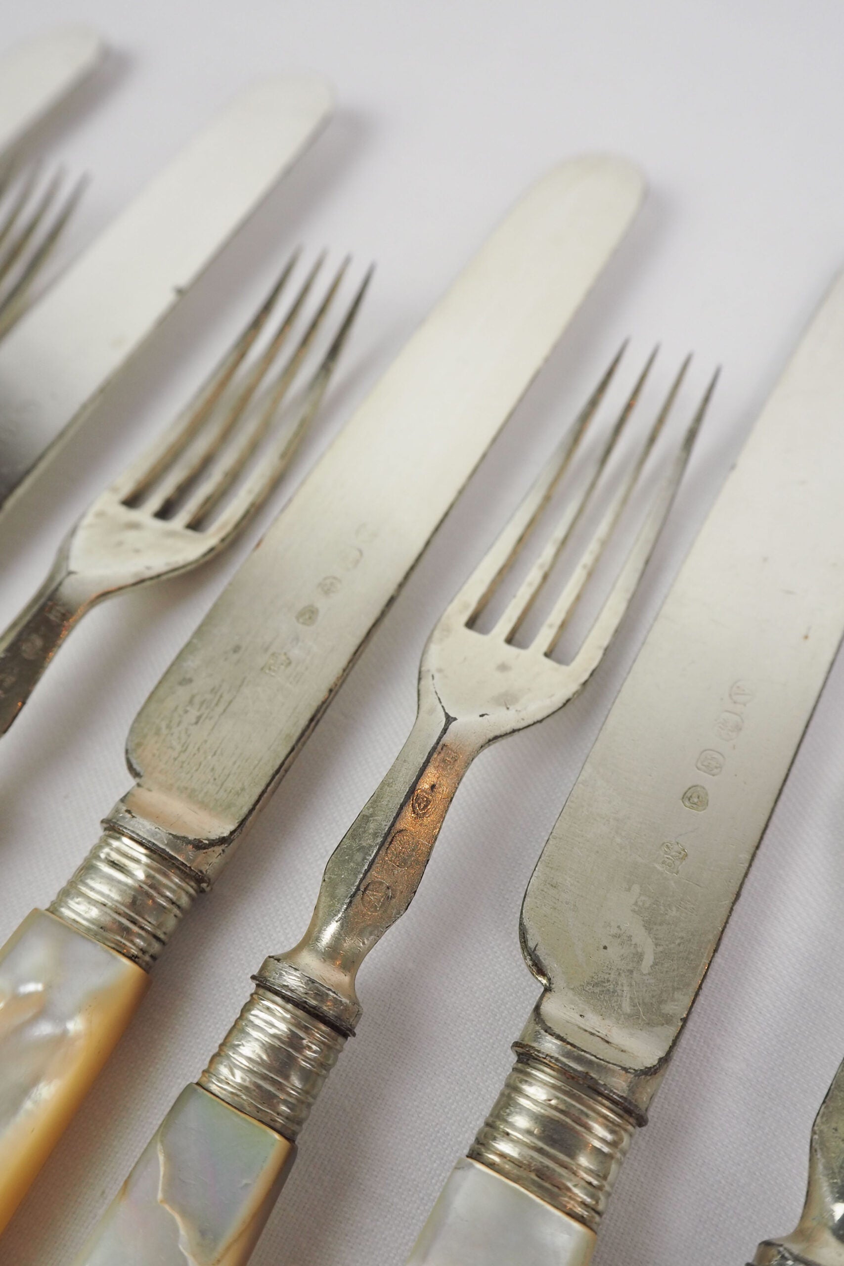 10 piece Antique Mother of Pearl Cutlery Set. The aged silver plate and mother of pearl handles give this set of knives and forks an antique look