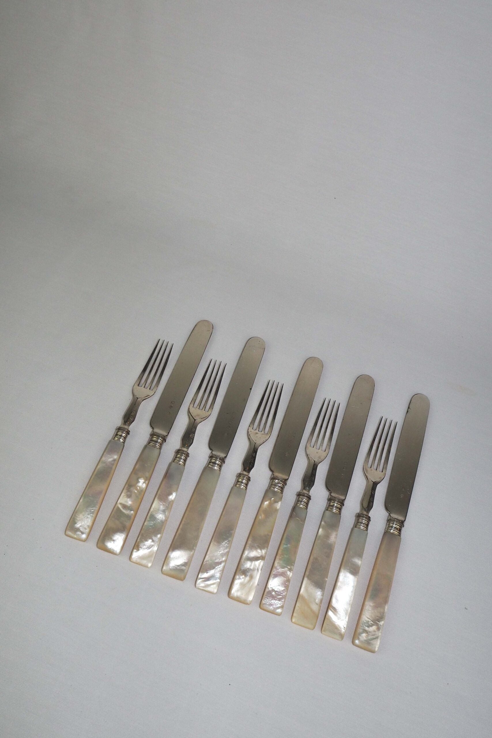 10 piece Antique Mother of Pearl Cutlery Set. The aged silver plate and mother of pearl handles give this set of knives and forks an antique look